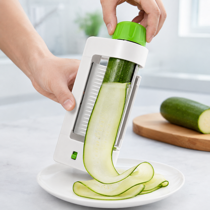 Manual vegetable slicer cutting a thin zucchini sheet