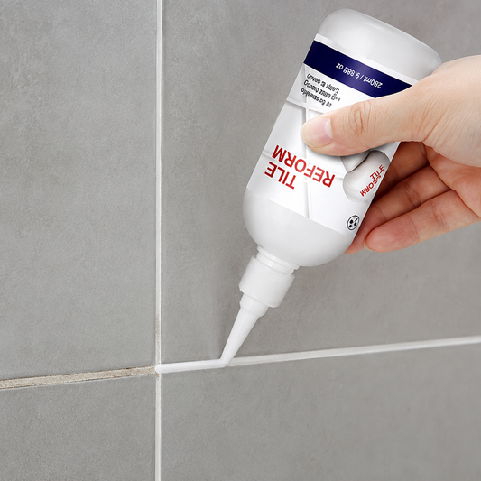 Applying white Tile Reform grout restorer to bathroom tile joints